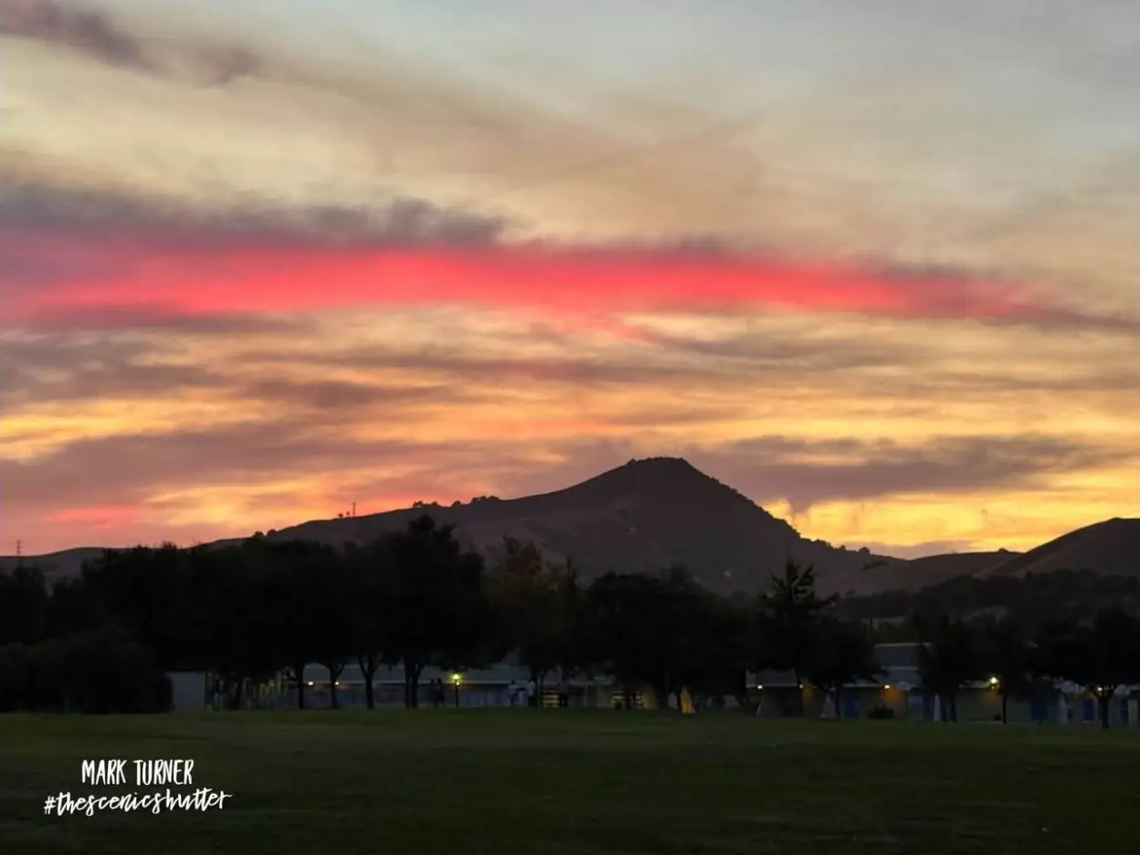 El Toro silhouetted beneath a pink and gold sunset in Morgan Hill, California
